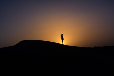 The silhouette of the setting sun on the mountain people
